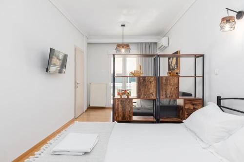 Un dormitorio con una cama con una computadora portátil encima. en Stavroula's House City Center, Penthouse, en Tesalónica