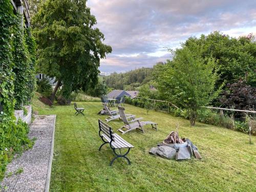 a group of park benches sitting in the grass at Willingenvakanties,Modern Quality Apartments Restyled nov 2022 WILLINGEN 2023 in Willingen