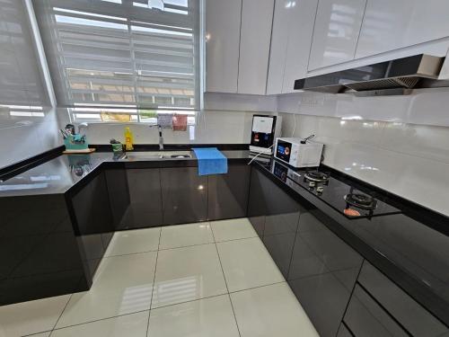 a kitchen with a sink and a counter top at JOVIAL SingleStorey Bungalow 4Room10Pax `Alma in Bukit Mertajam