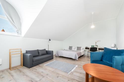 a living room with two blue chairs and a table at Bern Boutique by Rikas Hotels in Tallinn