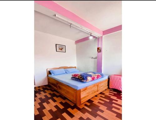 a bedroom with a bed in a room with purple walls at Blone Homestay by StayApart in Māngwa