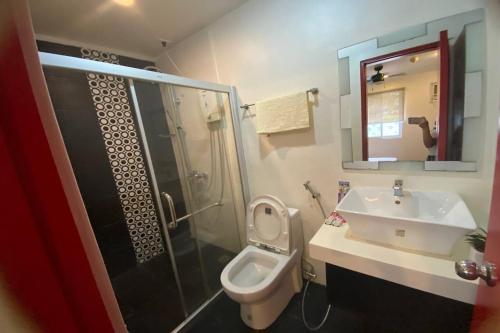 a bathroom with a sink and a toilet and a shower at Micasa Lodge Palawan in Coron