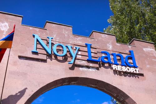 a sign that says new land on the side of a building at Noy Land Resort in Sevan