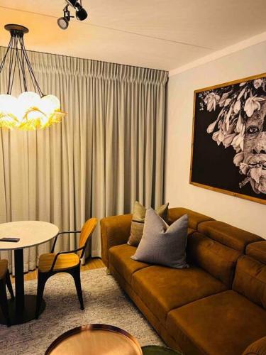 a living room with a couch and a table at The Steynview Pad - Pvt Garden Unit w/ Power Backup in Sandton