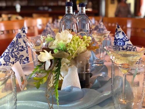 a table with blue and white plates and wine bottles at JazzPenzion in Čadca