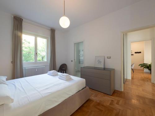 a bedroom with a large white bed and a window at Big apartment close to Bocconi / Humanitas / IEO in Milan