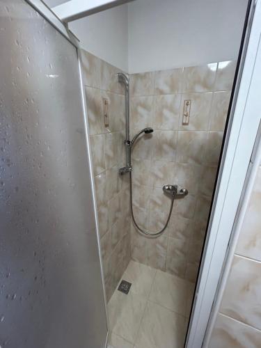 a shower with a glass door in a bathroom at Apartmán Studničky v centre Žiliny in Žilina