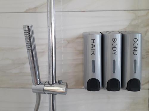 a shelf with three silver devices on a wall at Notte di Note - home hospitality in Busto Arsizio