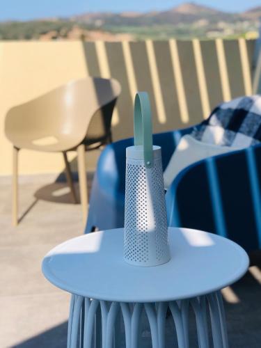 a blue table with a cup on top of it at Meliora Suites in Drapaniás