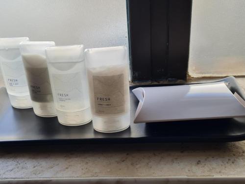 a shelf with four bottles of facial products on it at Aan de Paarlberg in Paarl