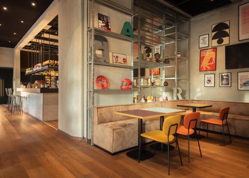 a restaurant with two tables and chairs in a room at Re Versiliana Hotel in Marina di Pietrasanta