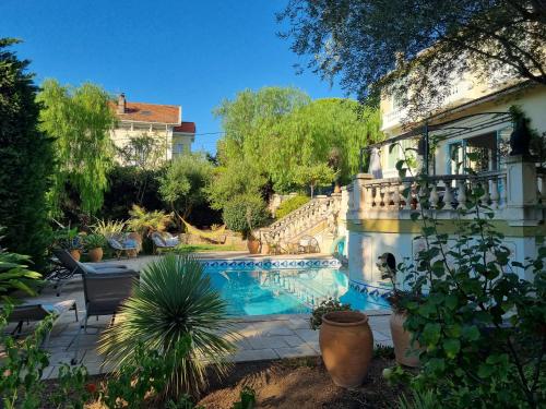 a swimming pool in the yard of a house at Villa Marguerite in Hyères