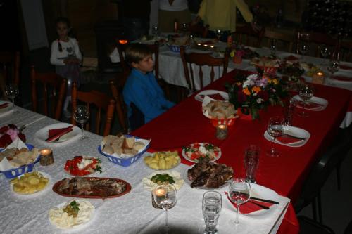 a child sitting at a table with food on it at Ethnic Grand Room -Tara Place in Mojkovac