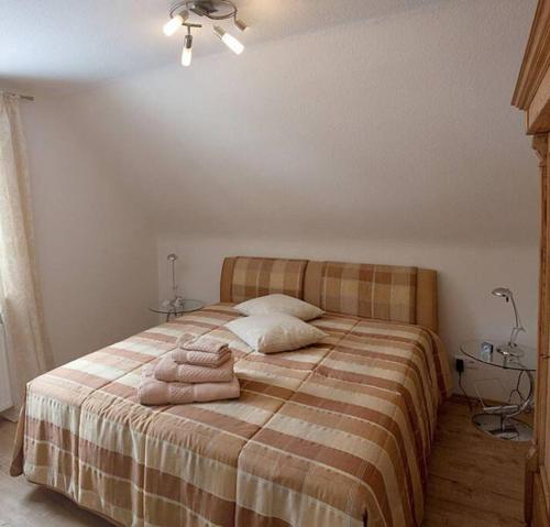 a bedroom with a bed with two towels on it at Harzhaus Romantica in Hahnenklee-Bockswiese