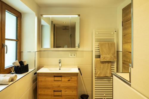 a bathroom with a sink and a mirror at Haus Lärche in Schönau am Königssee
