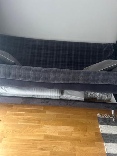 a bed with a blanket and pillows on a floor at Oja 118 Apartment in Pärnu