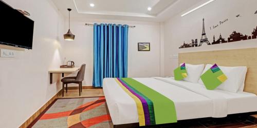 a hotel room with a bed and a desk at De Crown Luxury Hotel in Kākināda
