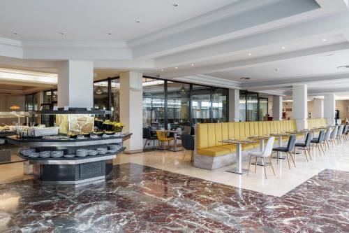 a lobby with a bar with chairs and tables at AluaSoul Orotava Valley - Adults Only in Puerto de la Cruz