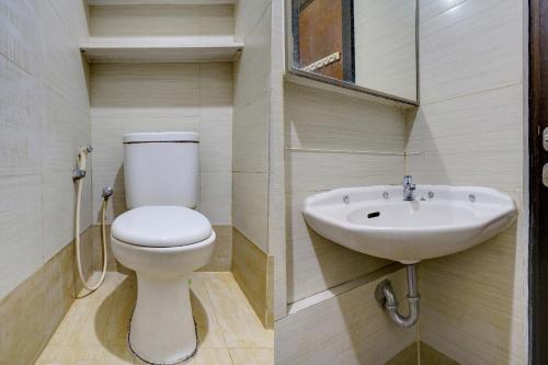 a bathroom with a toilet and a sink at OYO Life 93097 Apartemen Gateway Pasteur By Kaisar Room in Bandung