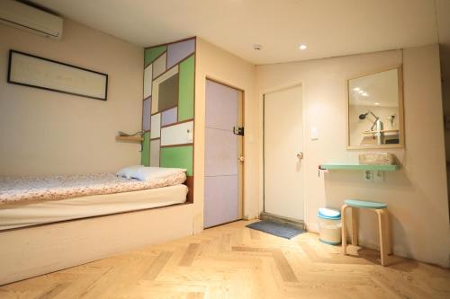 a small room with a bed and a table at SISnBRO Guesthouse in Seoul