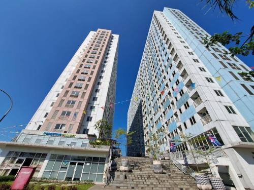 zwei hohe Gebäude nebeneinander in der Unterkunft OYO Life 93140 Apartment Grand Sentraland By Fahri in Jaken 1