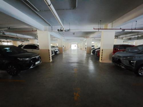 a large parking garage with cars parked in it at OYO Life 93140 Apartment Grand Sentraland By Fahri in Jaken 1