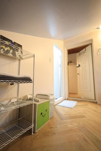 a room with bunk beds and a room with a door at SISnBRO Guesthouse in Seoul