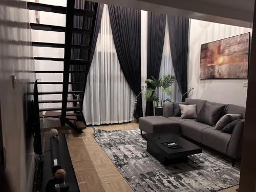 a living room with a couch and a table at COC00N by IVY in Lagos