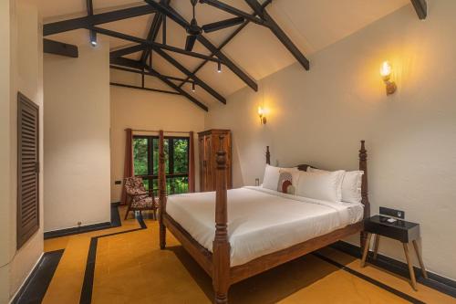 a bedroom with a bed in a room at SaffronStays Amavi Beach House in Dapoli