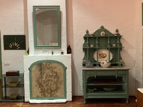 two green cabinets and a mirror on a wall at Holiday Home Finca SANT JAUME in Alaior