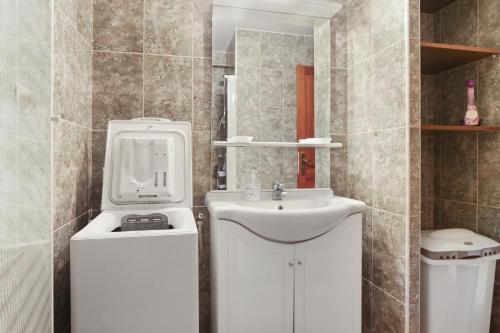 une salle de bain blanche avec un lavabo et des toilettes dans l'établissement Rez de Jardin dans Villa, à Saint-Raphaël