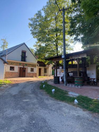 an old building with a pole next to a road at WBS Vinařství U Lisu Znojmo 6345 in Znojmo
