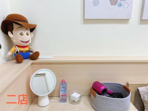 a stuffed animal sitting on a shelf next to a mirror at Unique Homestay in Tainan