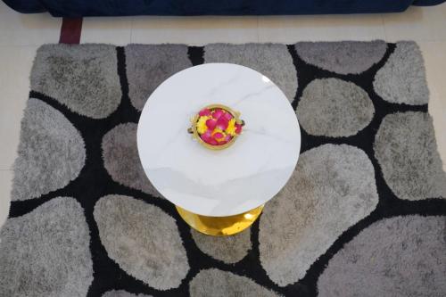 a plate with a donut on a table on a carpet at Visalam service apartment in Chennai