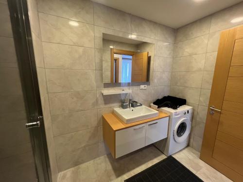 a bathroom with a sink and a washing machine at Cozy Homes 1 Room 1 Living room Apartment in Esenyurt