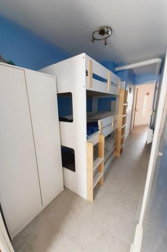 a room with a white bunk bed and blue walls at Latte mer in Palavas-les-Flots