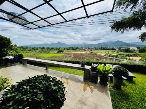 a view of a garden with a bench and plants at Amante Baristro Hotel & Cafe' @Pua in Nan