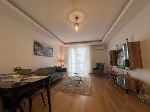 a living room with a couch and a table at Cozy Homes 1 Room 1 Living room Apartment in Esenyurt