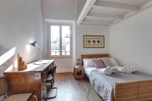 a bedroom with a desk and a bed and a dresser at Mamo Florence - Il Prato Apartment in Florence