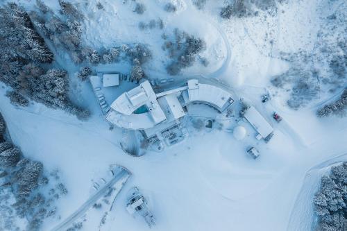 an aerial view of a building in the snow at Holzhotel Forsthofalm in Leogang