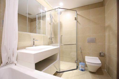 a bathroom with a shower and a sink and a toilet at Investland- Vinhomes Metropolis one, two, three, four bedrooms in Hanoi