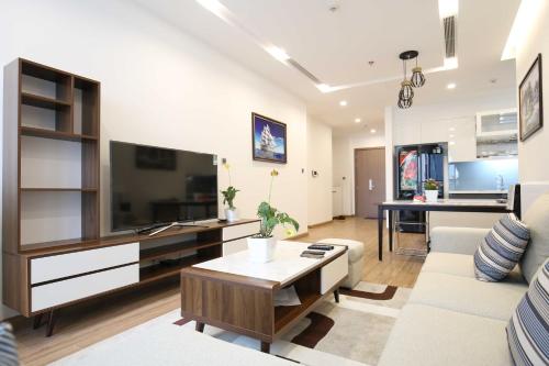 a living room with a large flat screen tv at Investland- Vinhomes Metropolis one, two, three, four bedrooms in Hanoi