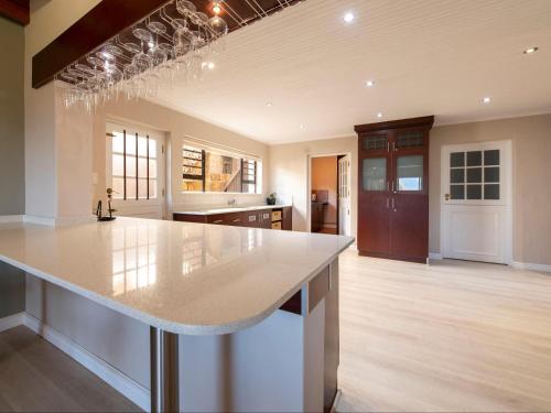 a large kitchen with a large marble counter top at Aan de Paarlberg in Paarl
