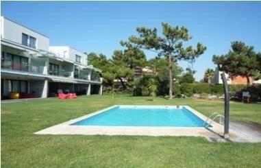 a swimming pool in the yard of a house at Casas Da Duna in Troia