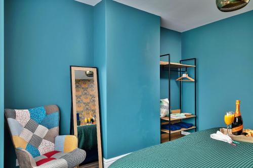 a blue room with a bed and a chair at Finest Retreats - Shorelands in Prestatyn