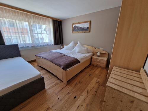 a small bedroom with a bed and a window at Ferienlandhaus Höfer in Fulpmes