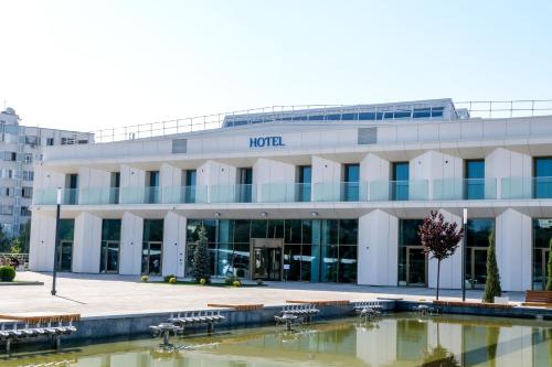 a building with a pool in front of it at M-clinic Hotel in Tashkent