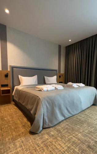 a bedroom with a large bed in a room at M-clinic Hotel in Tashkent