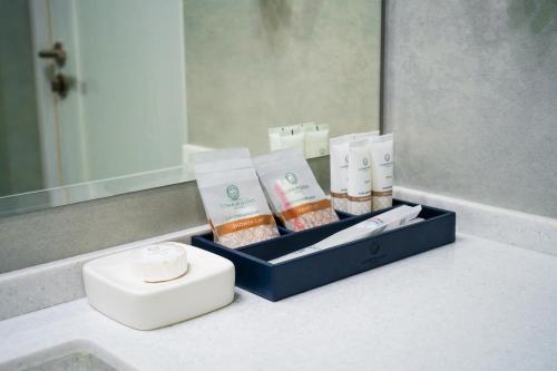 a box of products sitting on a bathroom counter at Cosmopolitan Hotel in Shymkent