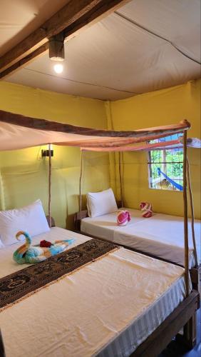 a bedroom with two bunk beds with a swan on them at Kohrong Sea Views Bungalows in Koh Rong Island